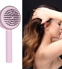 Air Cushion Massager Brush With Retractable Bristles Pink with side view of model