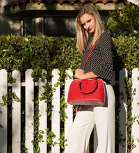 Elegant Red Saffiano Leather Satchel displayed by a beautiful Lady with a side view