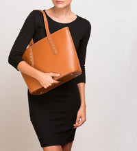 Brown Saffiano leather Tote accented with metallic studs with model